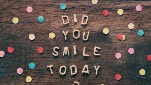 the words did you smile today written on a wooden surface